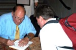 photo of Willard, autographing a copy of his book